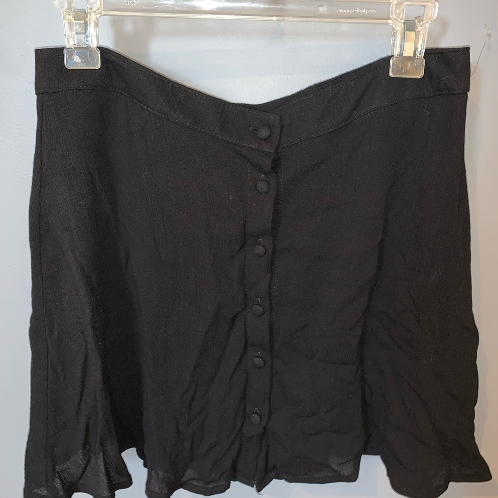 Black skirt, not tight, buttons down the middle